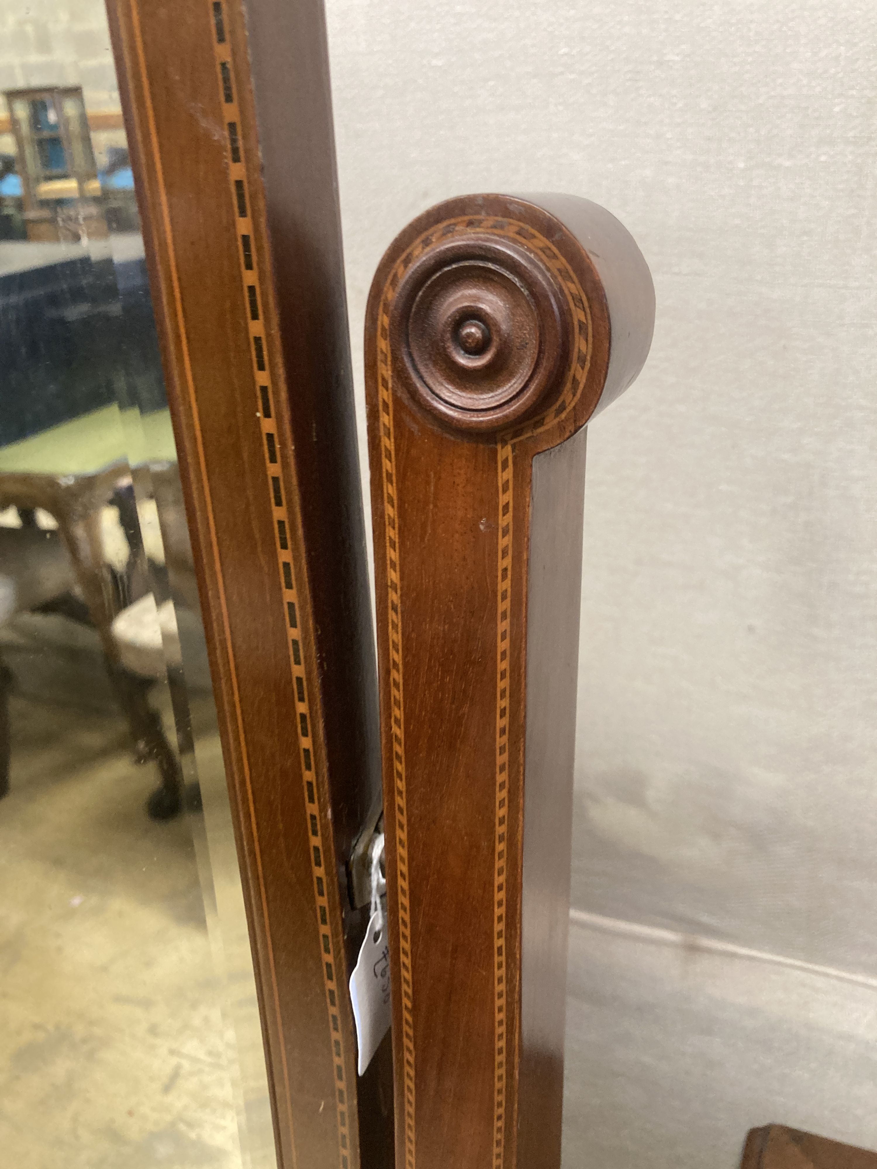 A large Edwardian inlaid mahogany shield shaped cheval mirror, width 80cm, height 177cm